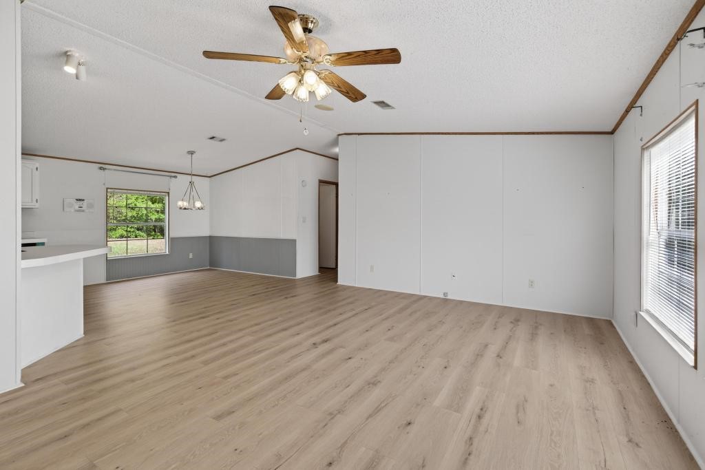 54059 Charles Street Callahan, FL 32011 - Photo 9 of 50 wooden floor in an empty room with a window