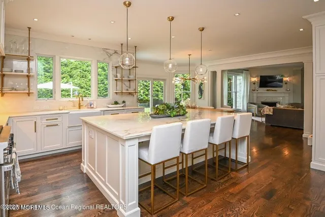 a kitchen with a table chairs and white cabinets