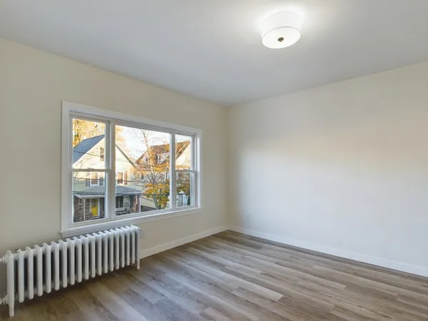 wooden floor in an empty room with a window