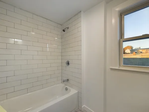 a bathroom with a bathtub and shower