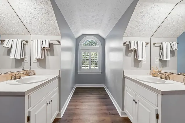 a view of a swimming pool with lawn chairs and a fire pit