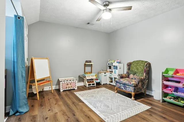 a view of a chair and tables in the backyard of the house