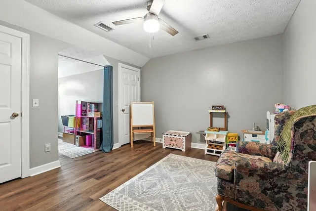 a view of a grassy field with trees in the background