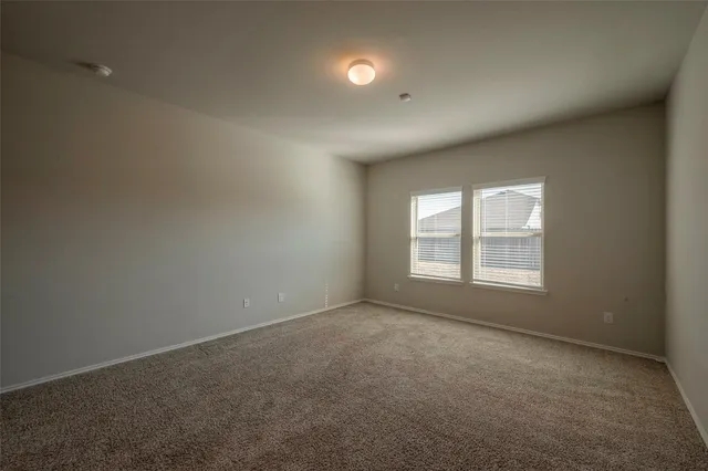 an empty room with a empty space and windows