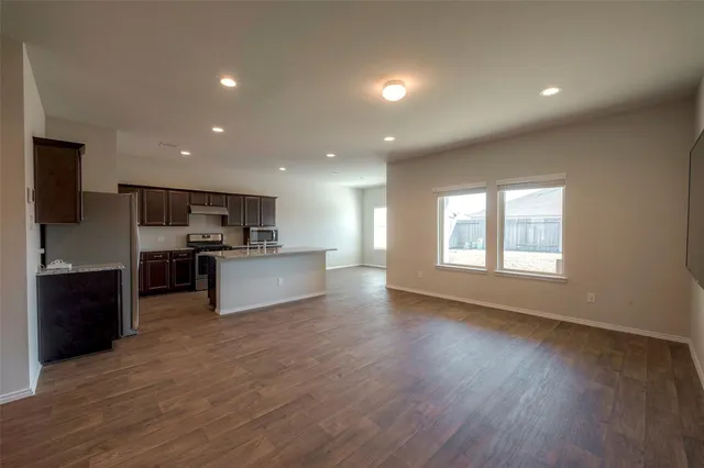 a view of kitchen with cabinets and wooden floor