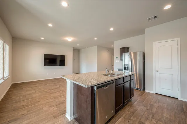 a kitchen with a sink and a refrigerator