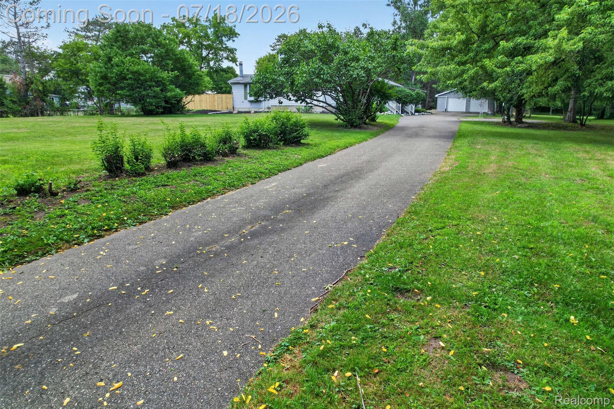 1437 East Cook Road Grand Blanc, MI 48439 - Photo 22 of 69 Asphalt driveway extending through a grassy landscape