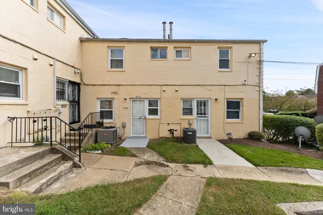 a front view of a house with a yard outdoor seating and barbeque oven