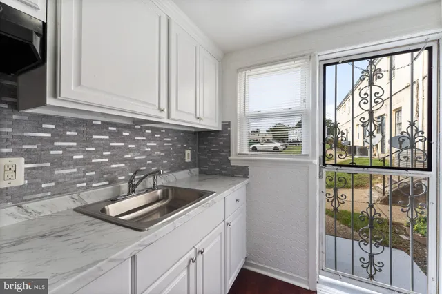 a kitchen with a sink and cabinets