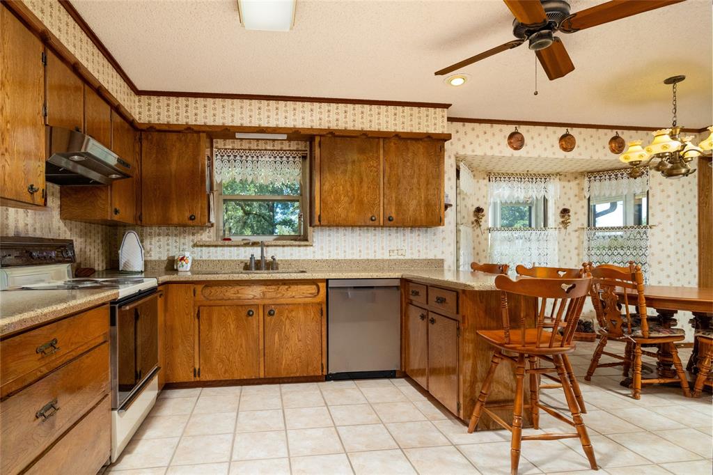 970 Live Oak Road Santo, TX 76472 - Photo 17 of 40 a kitchen with a sink cabinets and window