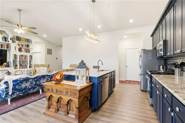 a kitchen with stainless steel appliances granite countertop a stove oven and a refrigerator