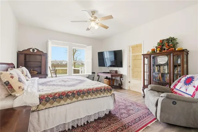 a living room with furniture a flat screen tv and a chandelier