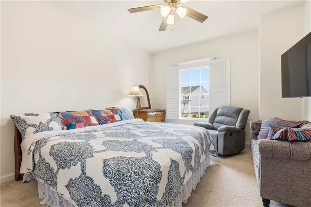 a bedroom with bed and a chandelier