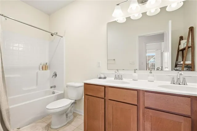 a bathroom with a toilet a sink a mirror a bathtub and vanity