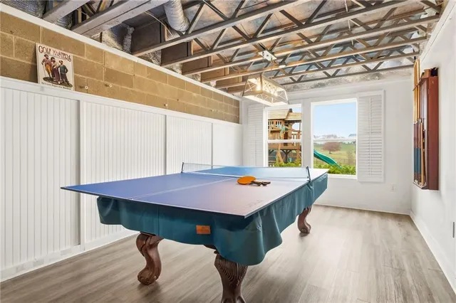 a dining hall with a stove a sink dishwasher and a wooden cabinets