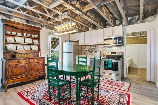 a kitchen with stainless steel appliances granite countertop a refrigerator and a stove top oven