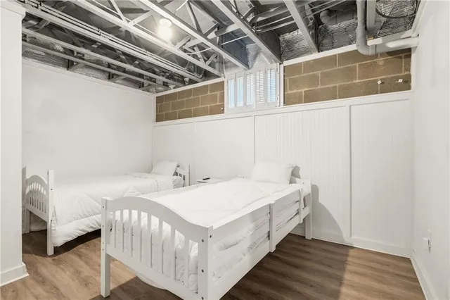 a bed sitting in a bedroom next to a window