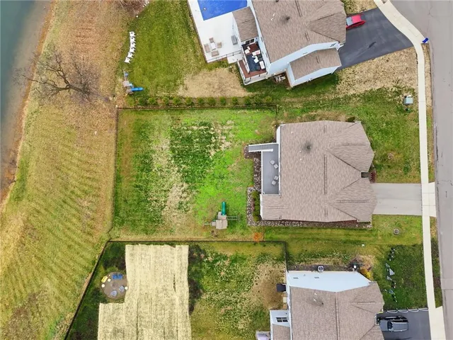 an aerial view of a house with a yard