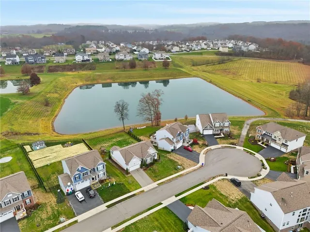 an aerial view of a house with a ocean view