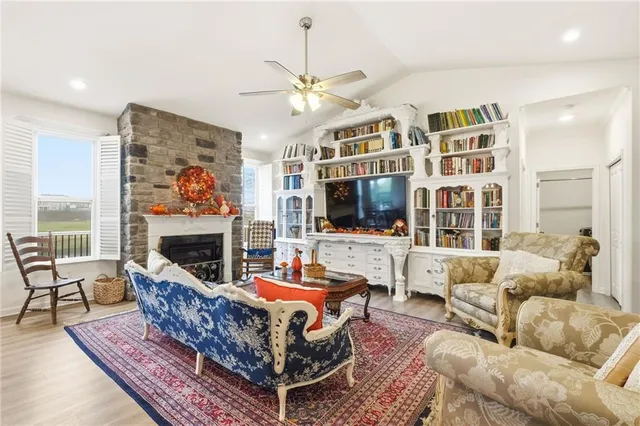 a living room with furniture a flat screen tv and a fireplace