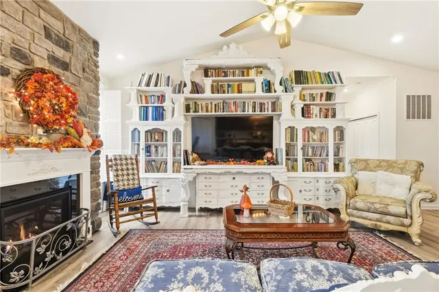 a living room with fireplace furniture and a flat screen tv