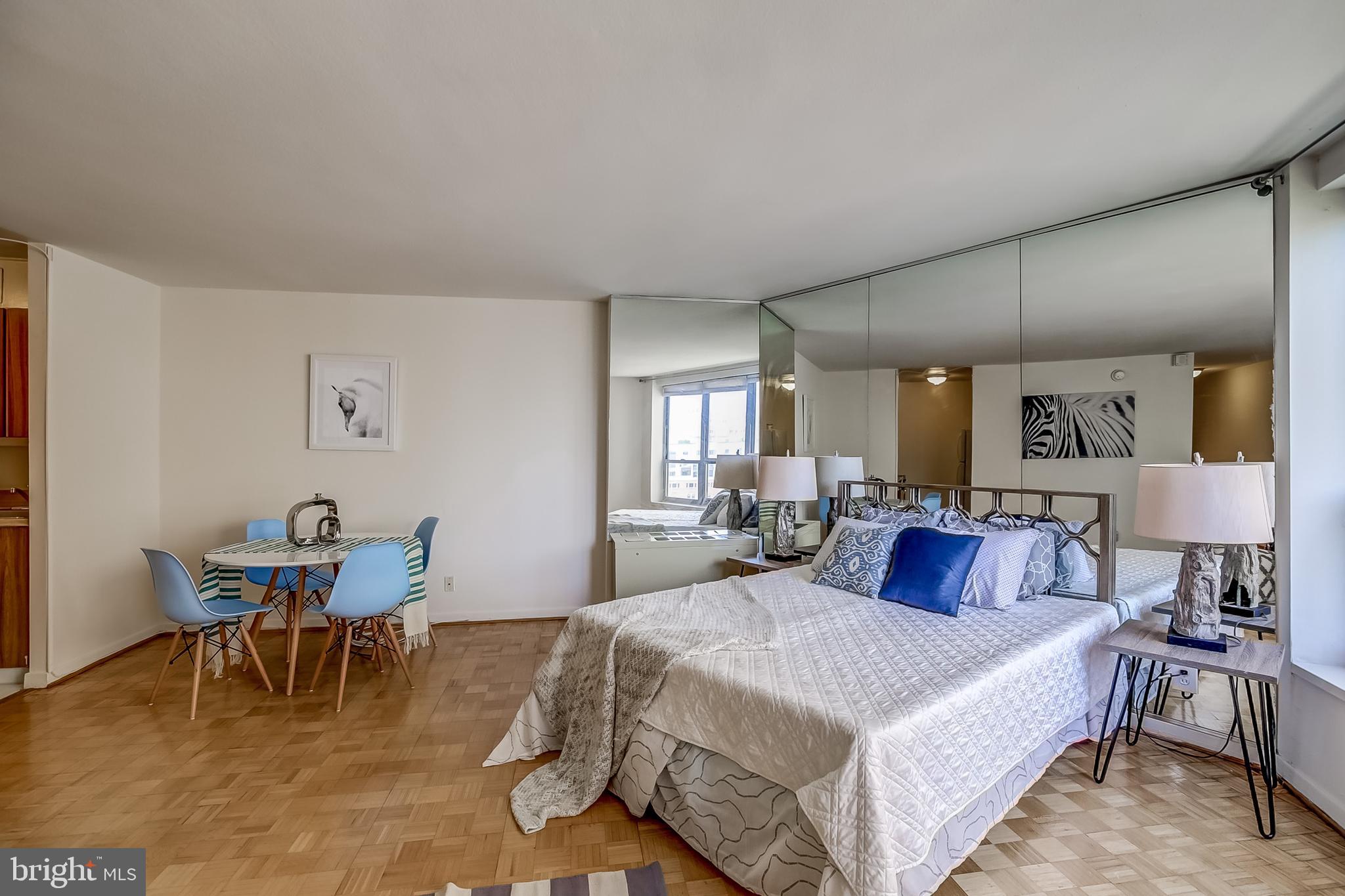 224-30 West Rittenhouse Square, Unit 2604 Philadelphia, PA 19103 - Photo 2 of 21 a bedroom with a bed a table and chair