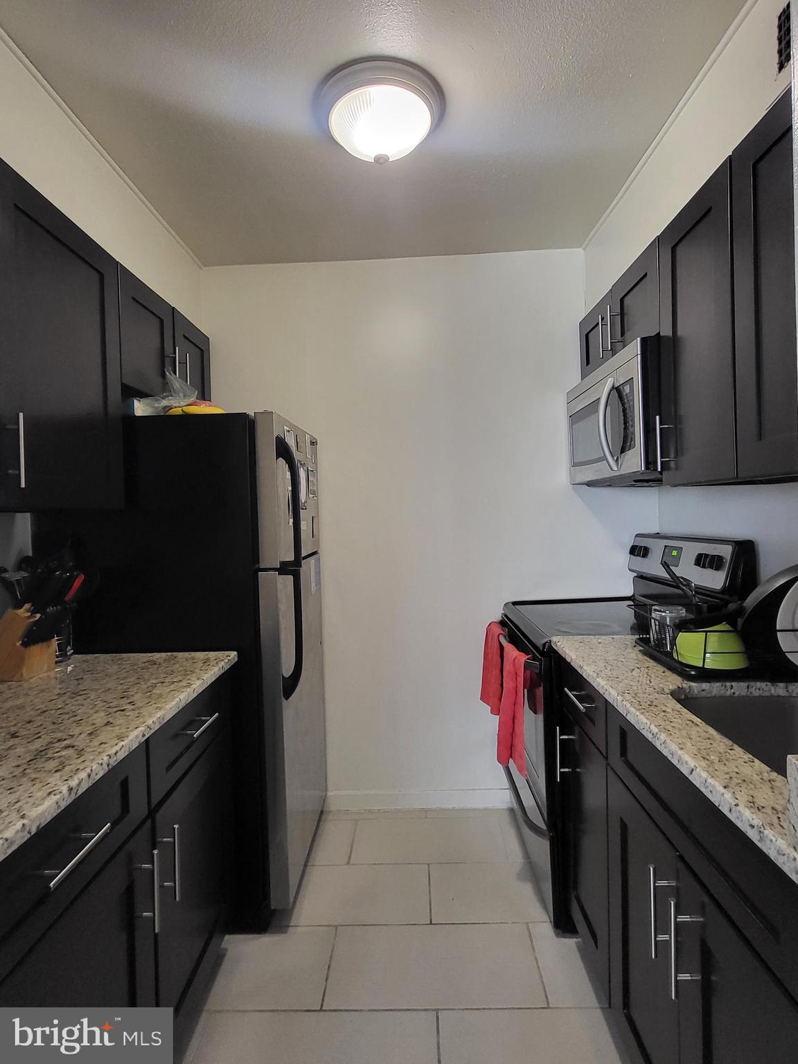 224-30 West Rittenhouse Square, Unit 2604 Philadelphia, PA 19103 - Photo 5 of 21 a kitchen with stainless steel appliances granite countertop a sink stove and refrigerator