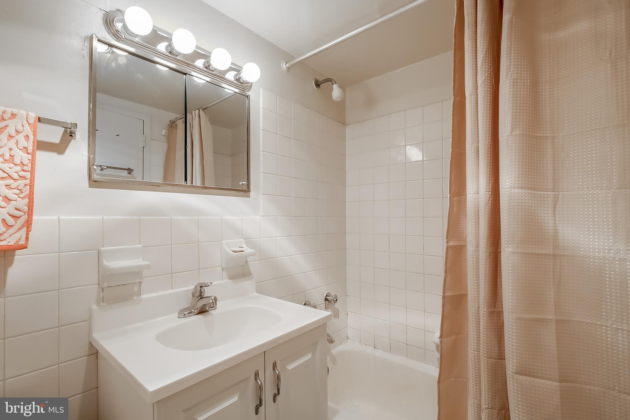 224-30 West Rittenhouse Square, Unit 2604 Philadelphia, PA 19103 - Photo 10 of 21 a bathroom with a sink mirror and shower