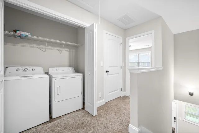a view of storage and utility room with washer and dryer