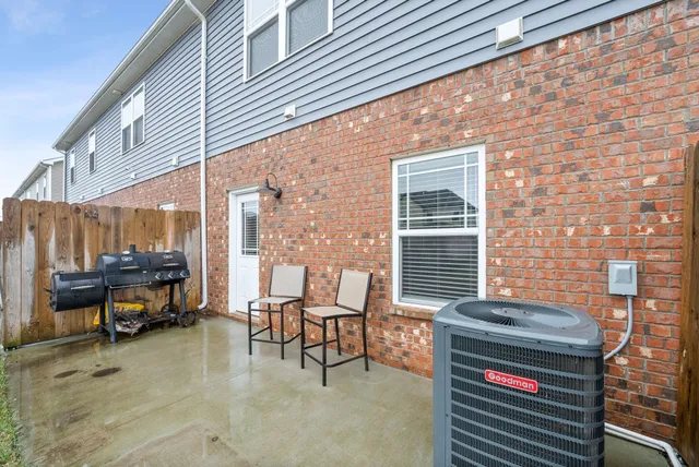 a view of a patio with a table and chairs