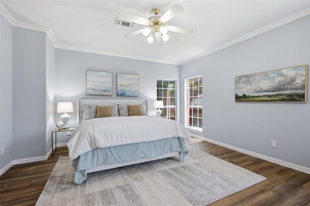 14584 Blueberry Court Addison, TX 75001 - Photo 20 of 40 a bedroom with a large bed and a chandelier