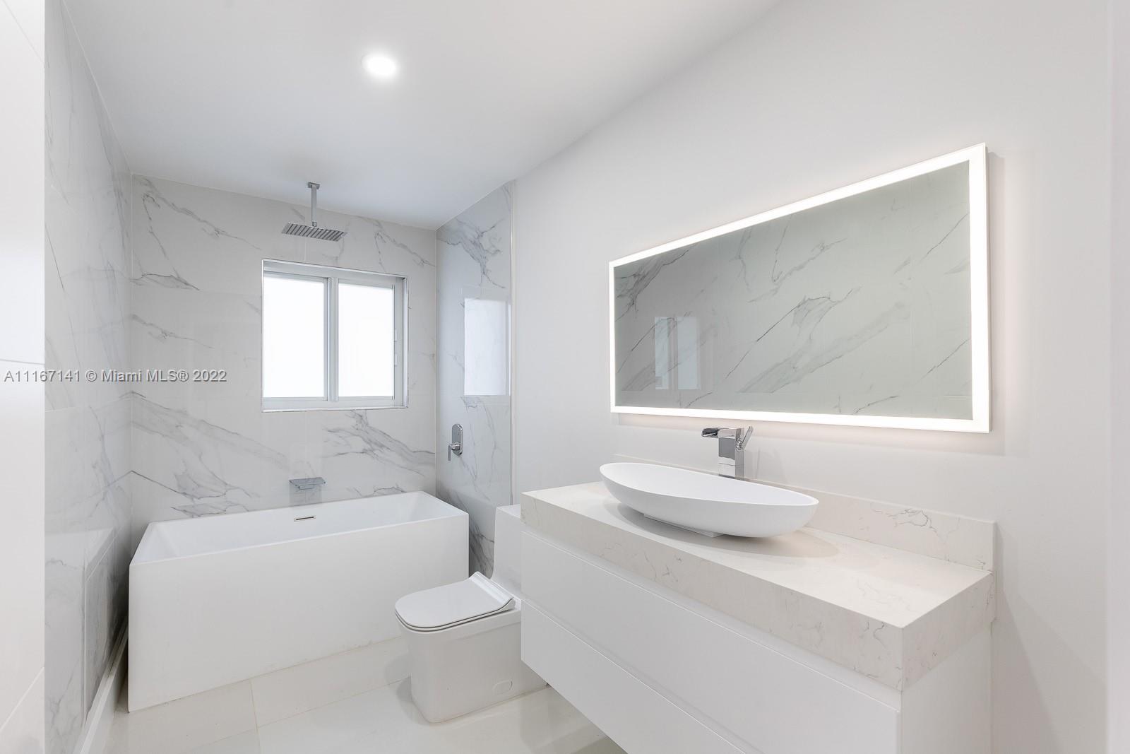 4730 Bay Point Road Miami, FL 33137 - Photo 13 of 25 a bathroom with a sink and a mirror