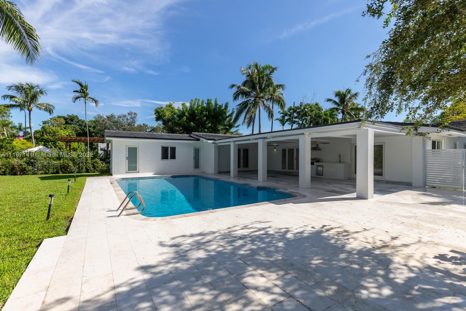 4730 Bay Point Road Miami, FL 33137 - Photo 3 of 25 a front view of a house with a yard and potted plants