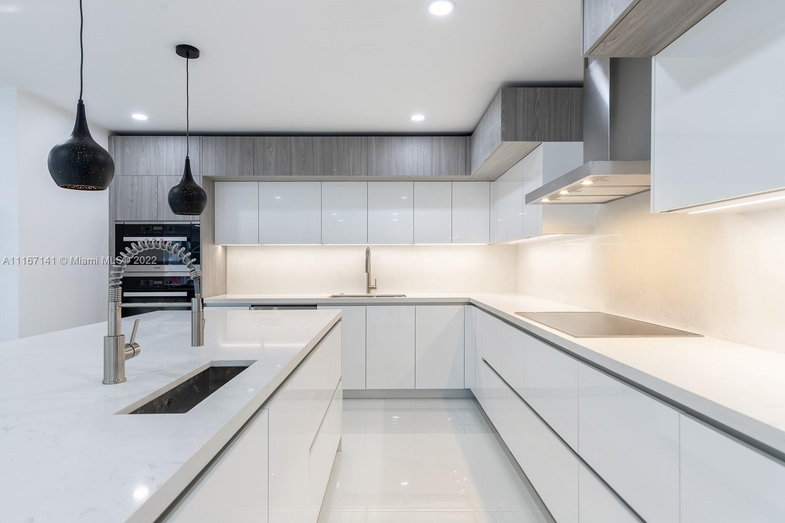 4730 Bay Point Road Miami, FL 33137 - Photo 8 of 25 a kitchen with a sink a stove and cabinets