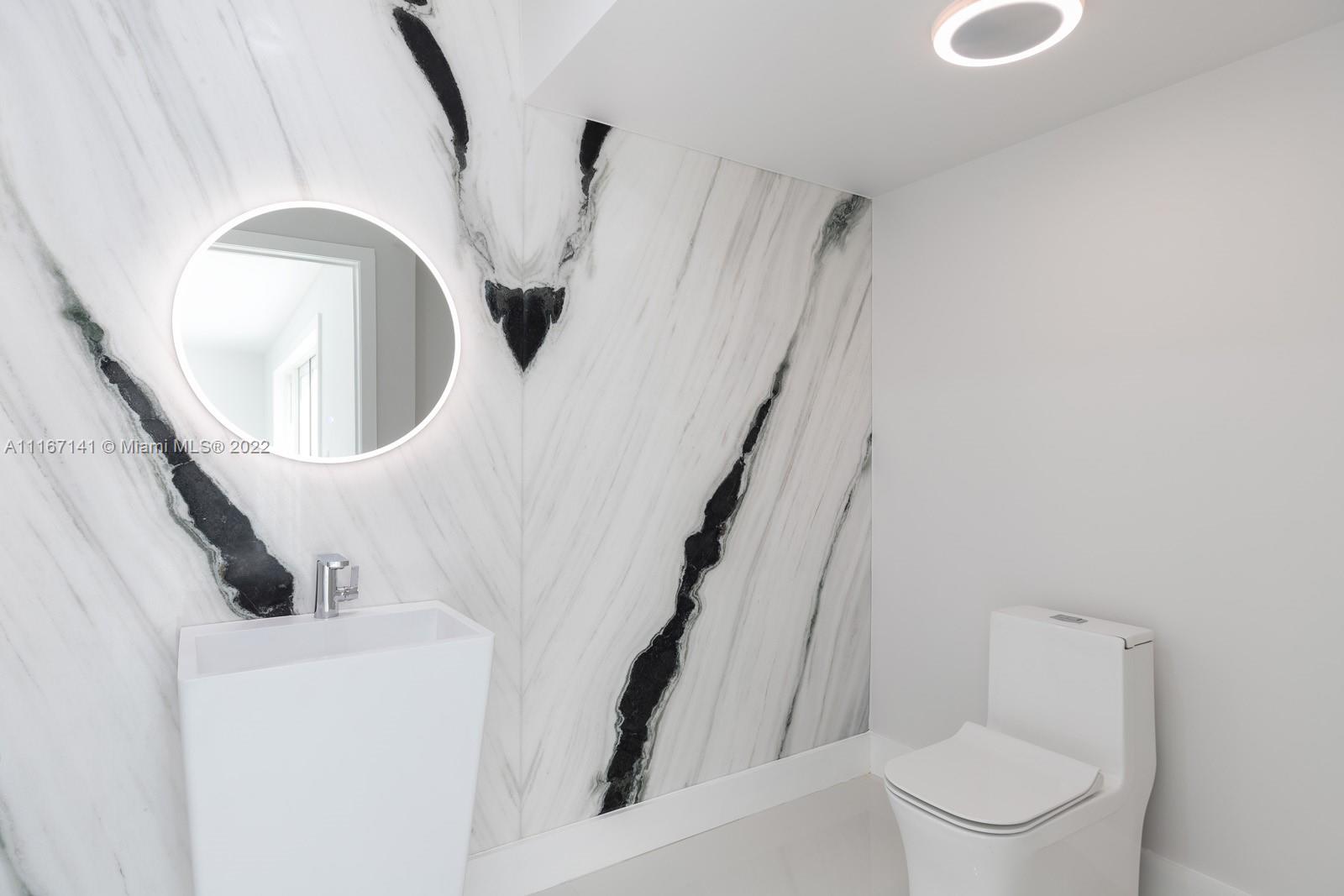 4730 Bay Point Road Miami, FL 33137 - Photo 9 of 25 a bathroom with a toilet and a mirror