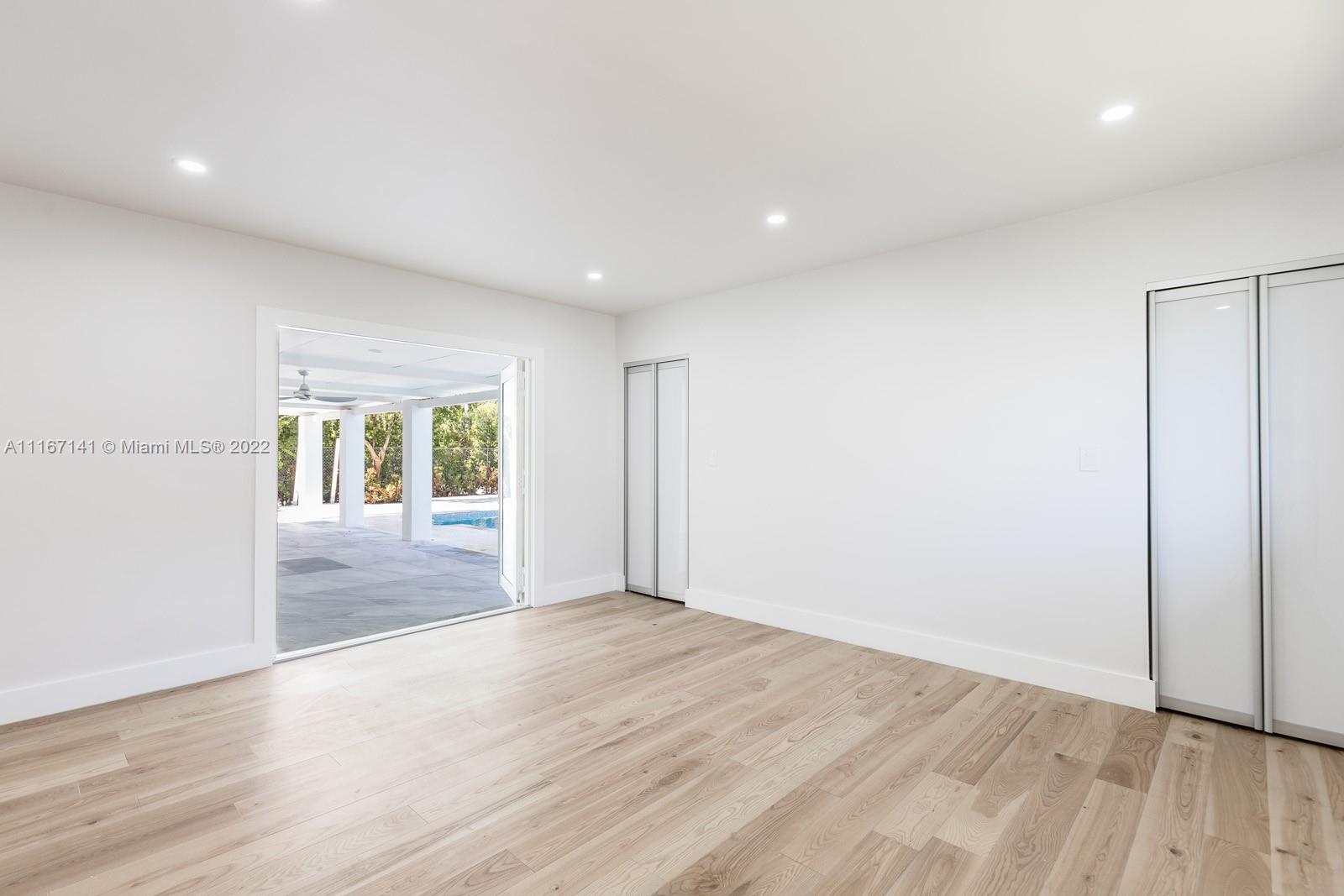 4730 Bay Point Road Miami, FL 33137 - Photo 10 of 25 wooden floor in an empty room with a window