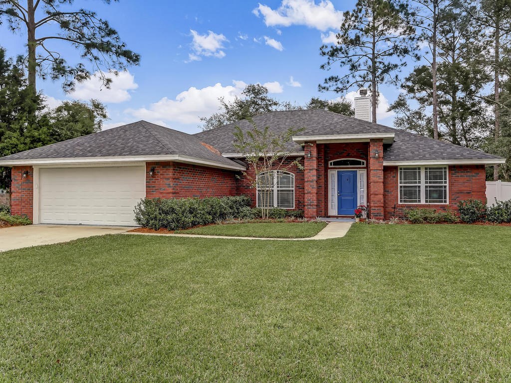 a front view of a house with a garden
