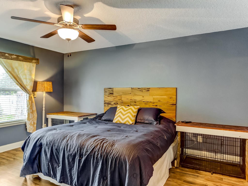 88358 Maybourne Road Yulee, FL 32097 - Photo 12 of 27 a bedroom with a bed and a chandelier