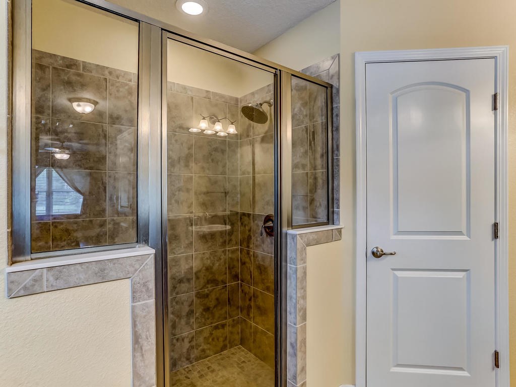 88358 Maybourne Road Yulee, FL 32097 - Photo 15 of 27 a bathroom with a glass shower door