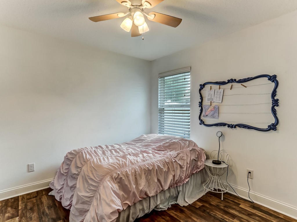 88358 Maybourne Road Yulee, FL 32097 - Photo 16 of 27 a bedroom with a bed and a chandelier