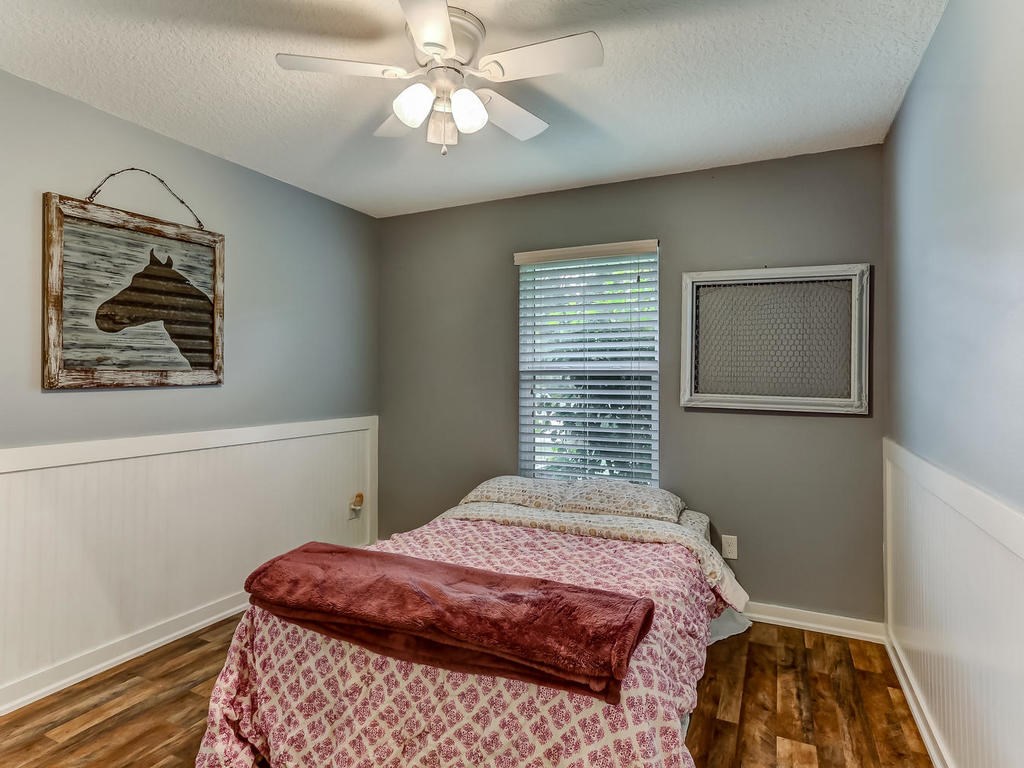 88358 Maybourne Road Yulee, FL 32097 - Photo 17 of 27 a bedroom with a bed and a painting on the wall