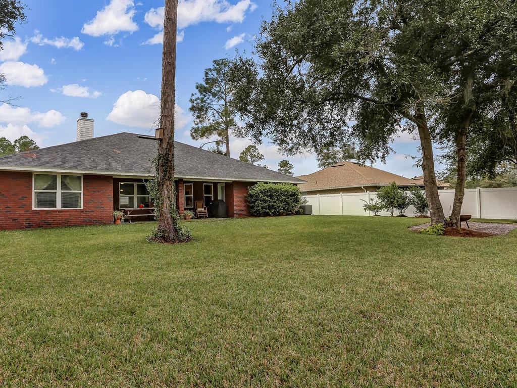 88358 Maybourne Road Yulee, FL 32097 - Photo 24 of 27 a view of a house with a yard