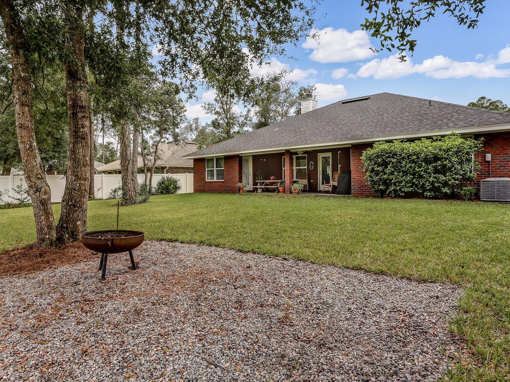 88358 Maybourne Road Yulee, FL 32097 - Photo 25 of 27 a view of a house with a yard