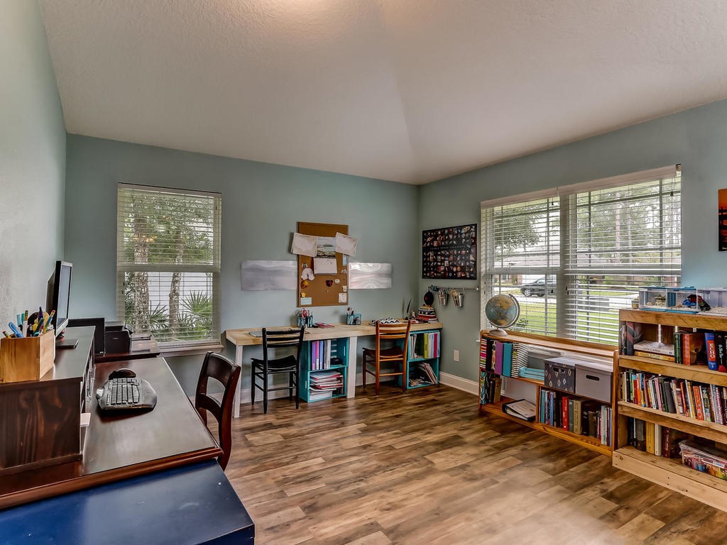 88358 Maybourne Road Yulee, FL 32097 - Photo 5 of 27 a living room with furniture a bookshelf and a window