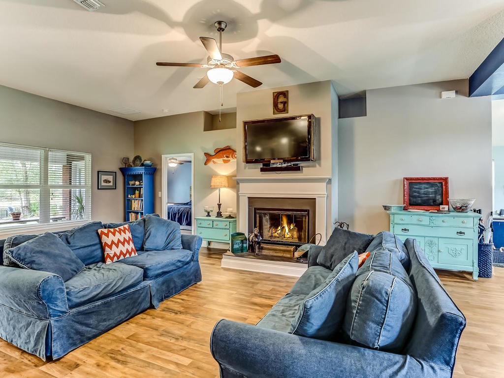 88358 Maybourne Road Yulee, FL 32097 - Photo 6 of 27 a living room with furniture a flat screen tv and a fireplace