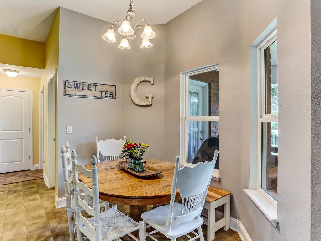 88358 Maybourne Road Yulee, FL 32097 - Photo 8 of 27 a view of a dining room with furniture and chandelier