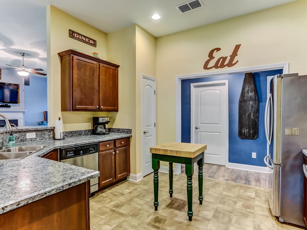 88358 Maybourne Road Yulee, FL 32097 - Photo 10 of 27 a kitchen with a refrigerator a sink and cabinets