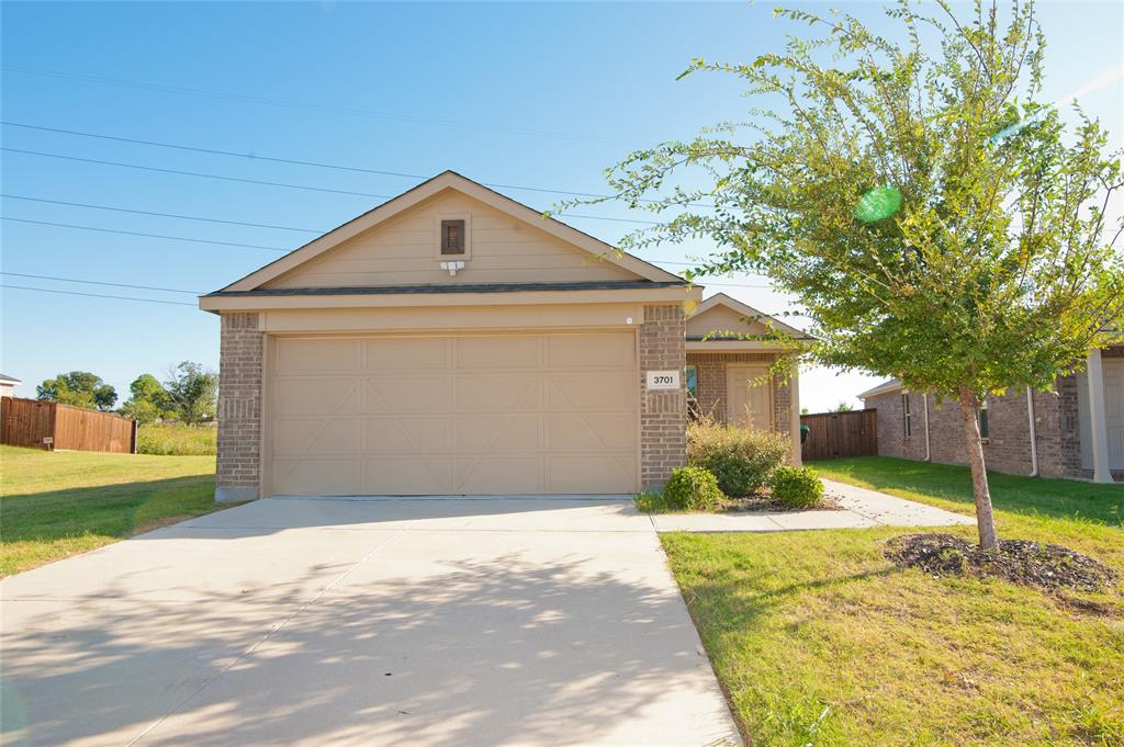 3701 Harper Street Little Elm, TX 75068 - Photo 1 of 26 a front view of a house with a yard and garage