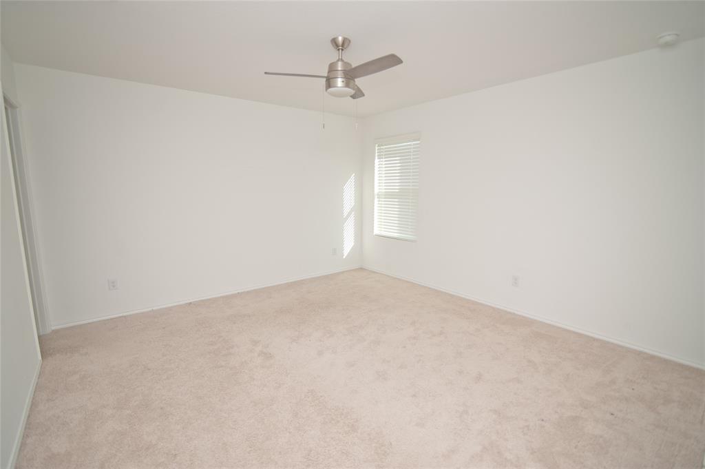 3701 Harper Street Little Elm, TX 75068 - Photo 9 of 26 an empty room with a ceiling fan and wooden floor