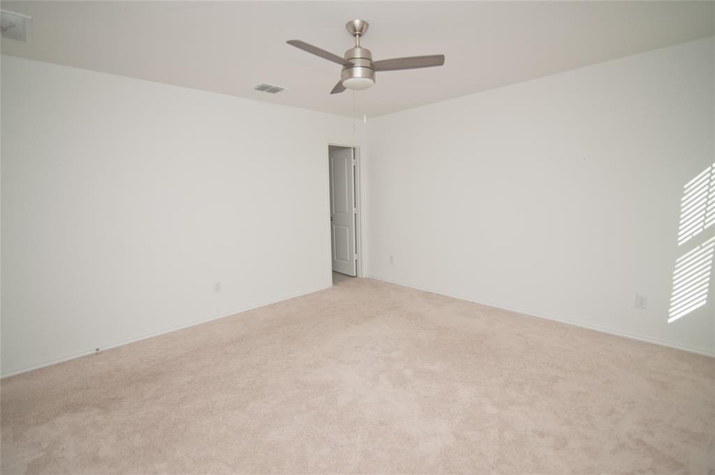 3701 Harper Street Little Elm, TX 75068 - Photo 10 of 26 an empty room with windows and fan